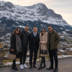 Enver, guide and host of Zurich Day Tour, welcoming international guests in the Swiss Alps with panoramic mountain views near Jungfrau.