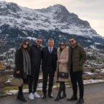 Enver, guide and host of Zurich Day Tour, welcoming international guests in the Swiss Alps with panoramic mountain views near Jungfrau.
